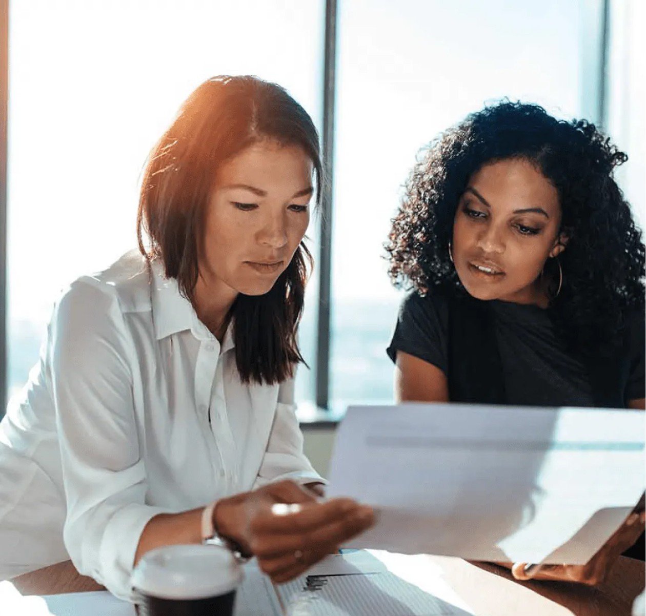 two workers observing printed chart