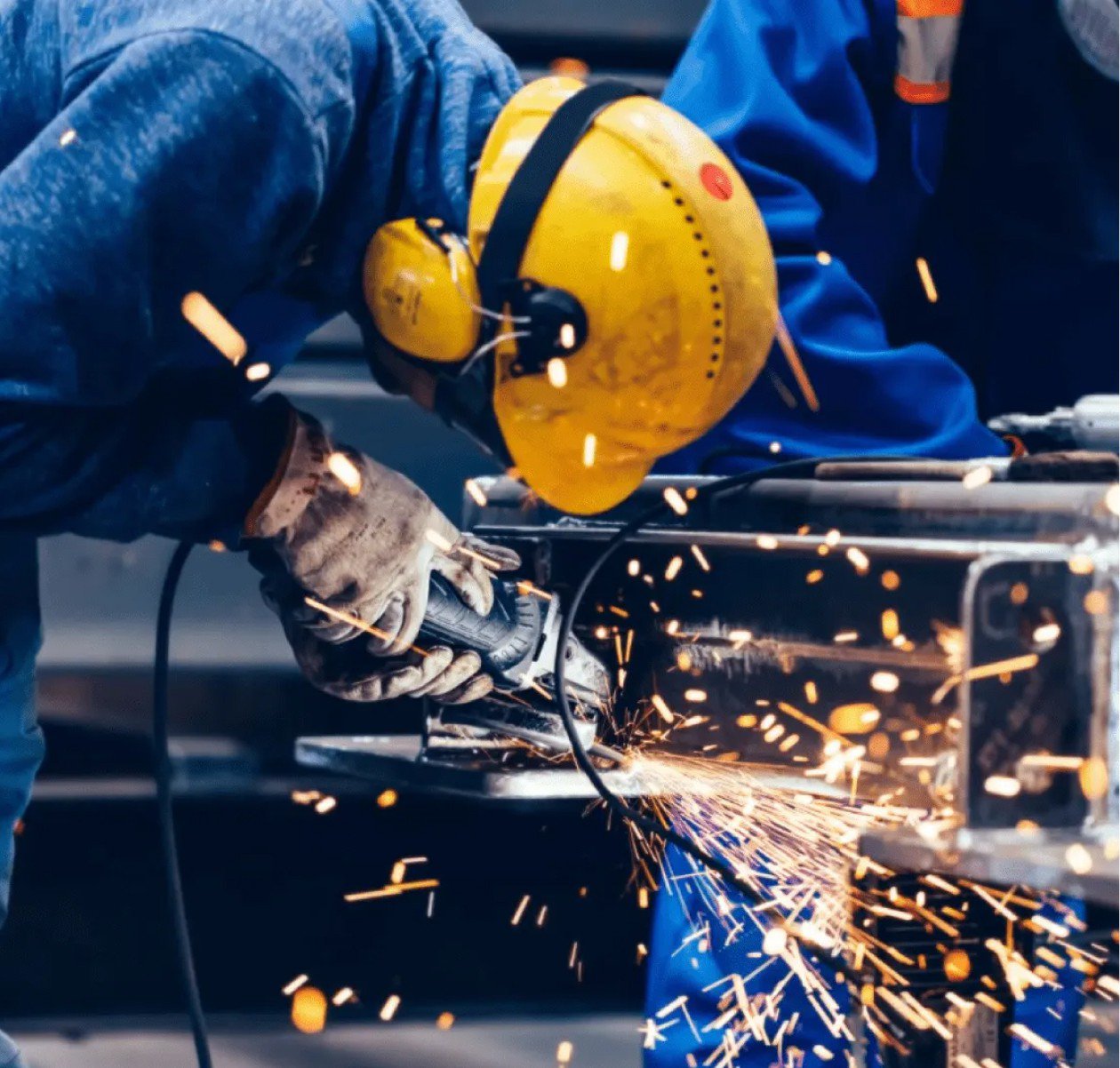 man in shop using angle grinder