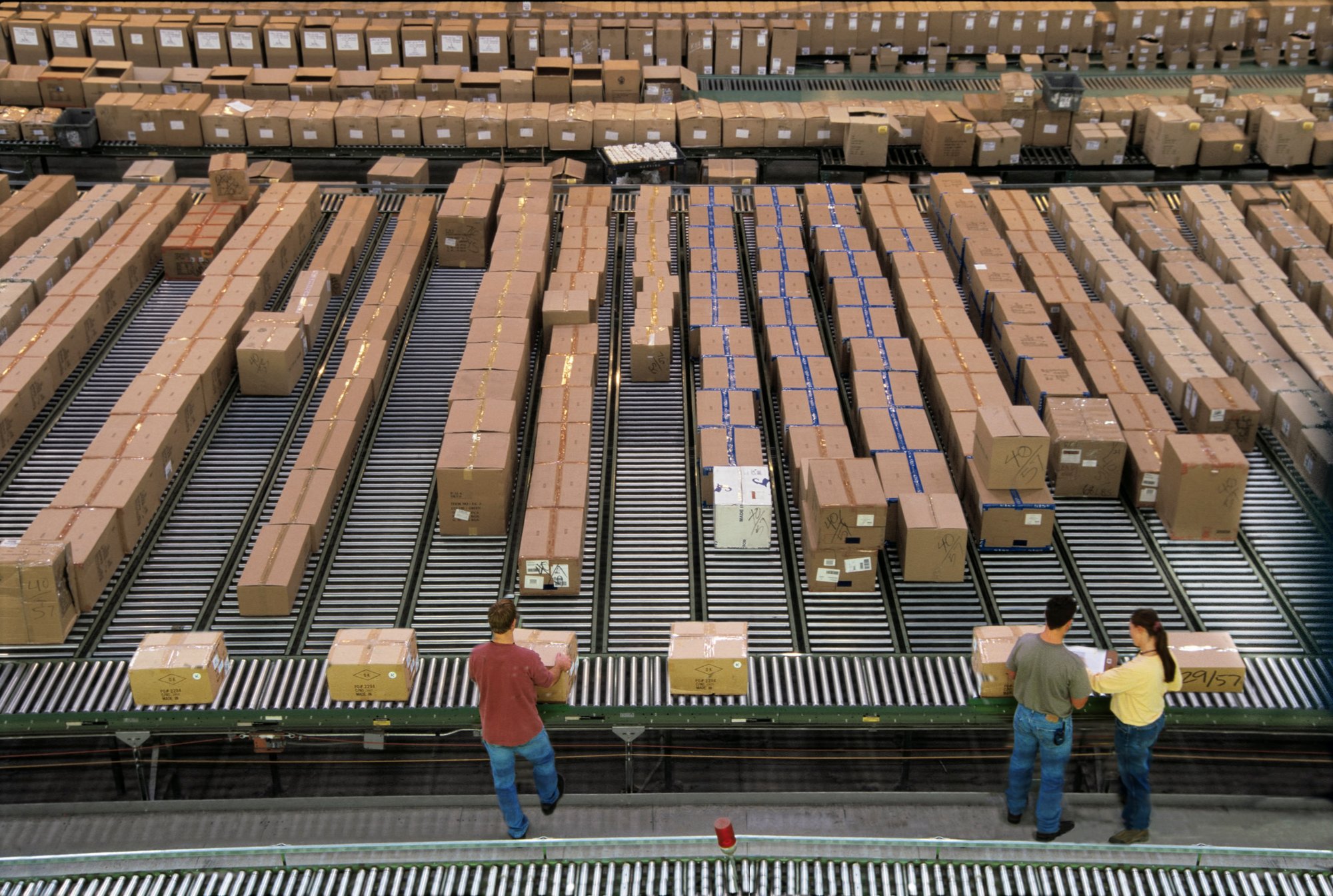 Overview of a large industrial distribution warehouse storing products in cardboard boxes on.