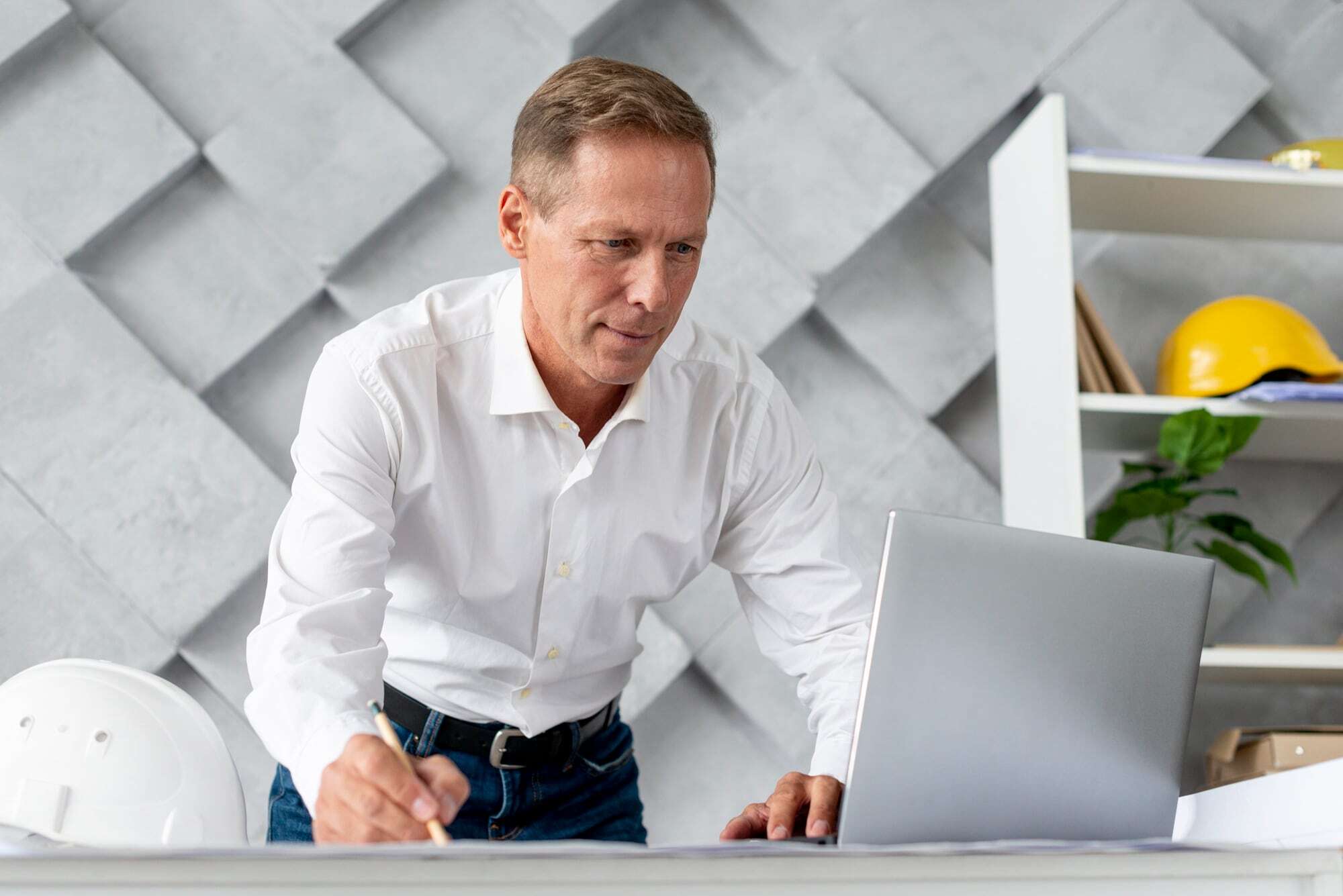 Manager working at a laptop in an office